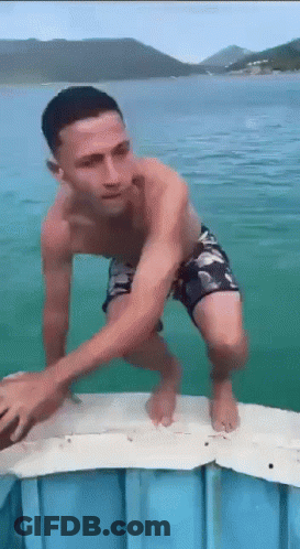 Man Without Shirt Standing On Dock GIF