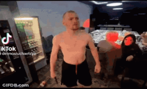Man Without Shirt Standing With TikTok Logo GIF