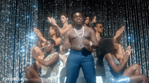 Man Without Shirt Surrounded By Women GIF