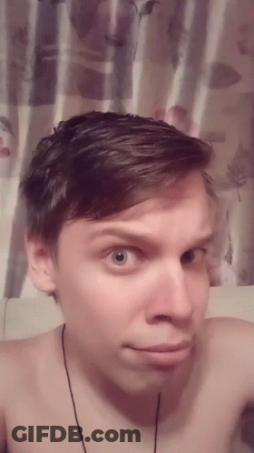 Man Without Shirt Taking Selfie In Front Of Floral Curtain GIF