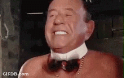 Man Without Shirt Wearing Bow Tie And Necklace GIF
