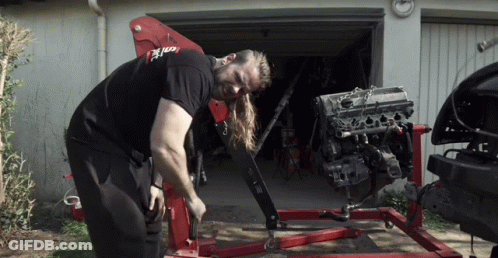 Man Working On Car Engine With Red Crane GIF