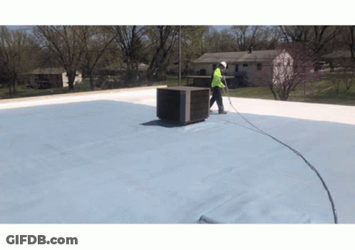 Man Working On Roof With Hose Attached GIF