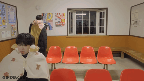 Man Wrapped In Blanket In Front Of Window GIF