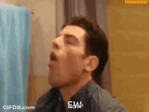 Man Yawning In Front Of Blue Shower Curtain GIF