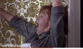 Man Yawning In Front Of Floral Wallpaper GIF