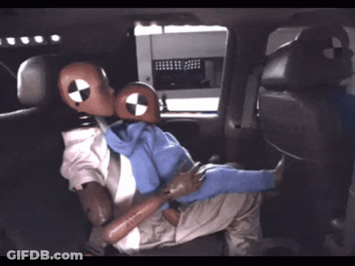 Mannequin In Suit And Tie Sitting In Back Seat Of Vehicle GIF