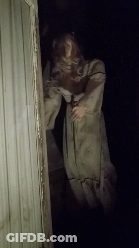 Mannequin In White Dress In Dark Doorway GIF