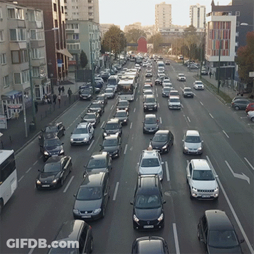 Many Cars Driving Down Street License Plate Starts With S GIF