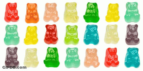 Many Different Colored Gummy Bears Are Lined Up In Rows GIF
