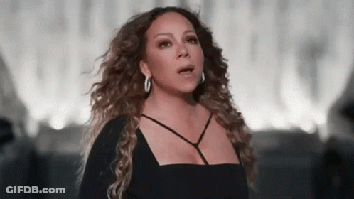 Mariah Carey In Black Dress And Hoop Earrings Singing GIF