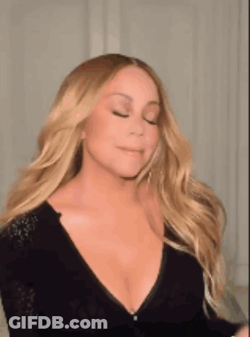 Mariah Carey In Black Plunging Dress With Earrings GIF