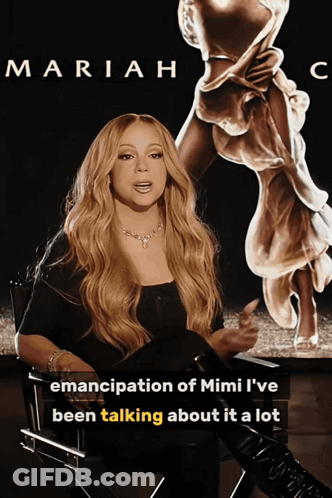 Mariah Poster In Front Of Mimi Statue GIF