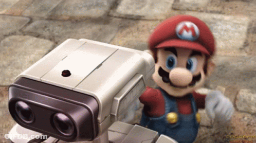 Mario Standing Next To Small Robot GIF