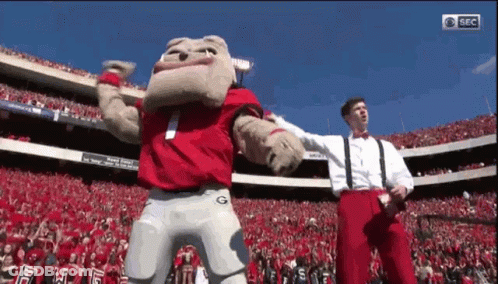 Mascot Dancing In Stadium With Two Men GIF