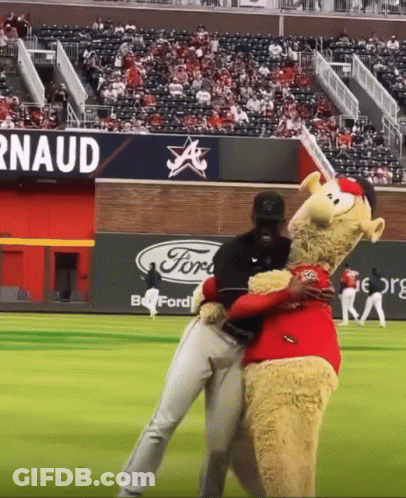 Mascot Hugging Baseball Player With Ford Sign GIF