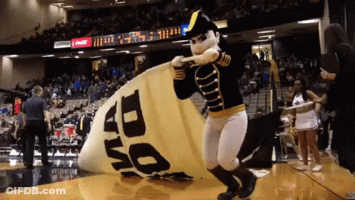 Mascot In Black And Gold Uniform In Front Of 1510 WLAC Sign GIF