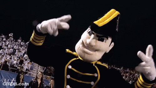 Mascot In Black And Yellow Uniform Pointing At Camera GIF