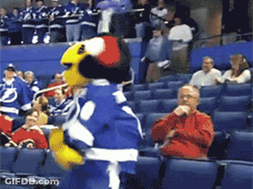 Mascot In Blue And White Outfit In Front Of Crowd GIF