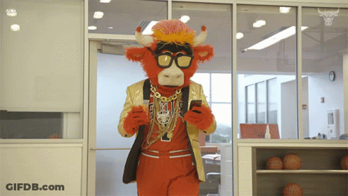 Mascot In Bull Costume Looking At Cell Phone GIF