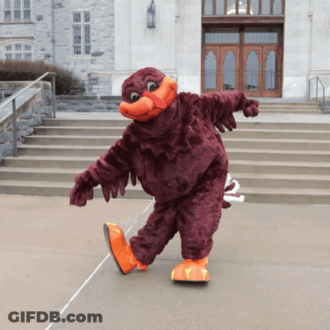 Mascot In Front Of Building With Stairs GIF