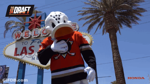 Mascot In Front Of Welcome To Las Vegas Sign GIF