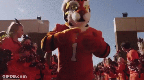 Mascot In Number 1 Jersey With Cheerleaders GIF