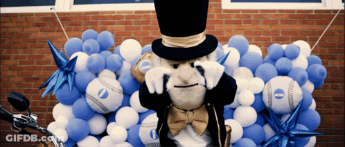 Mascot In Top Hat Surrounded By NCAA Balloons GIF