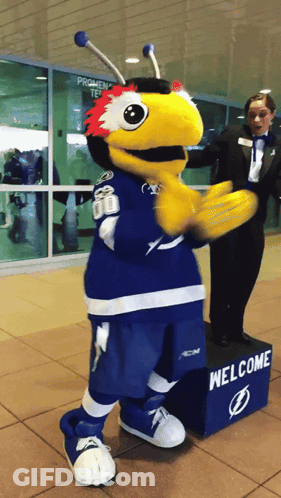 Mascot Next To Welcome Sign GIF