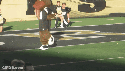Mascot On Field With Letter S Behind GIF