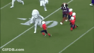 Mascot On Football Field With Referee GIF