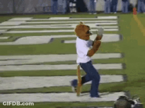 Mascot Running On Football Field In White Shirt And Blue Jeans GIF