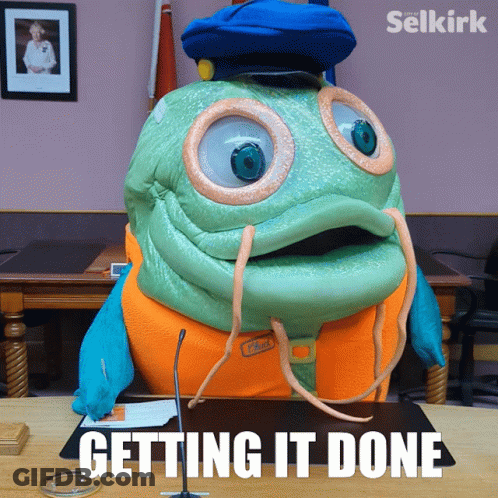 Mascot Sitting At Desk Getting It Done GIF