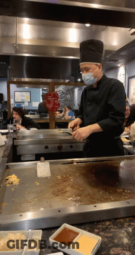 Masked Chef Preparing Food Near Valentine's Day Sign GIF