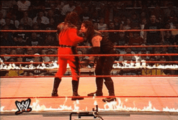 Masked Kane Chokeslam Opponent On Burning Ring GIF