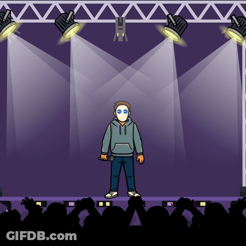 Masked Man Holding Microphone On Stage GIF