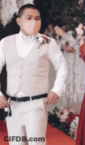 Masked Man In White Suit On Red Carpet GIF