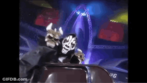 Masked Man Sitting In Stadium With Stage GIF
