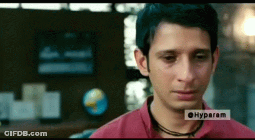 Masked Man Talking To Another Man Tu Sei Pieno Fino Qua Oggi GIF