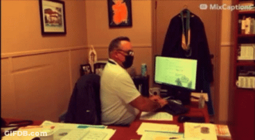 Masked Man Typing On Computer GIF
