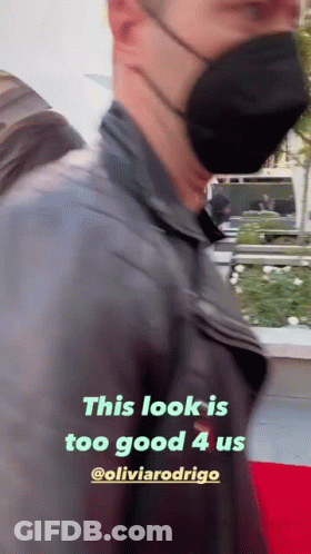 Masked Man Walking On Red Carpet GIF