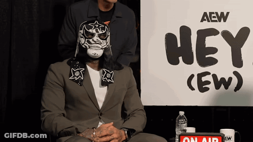 Masked Man With Sign Saying Hey Ew GIF