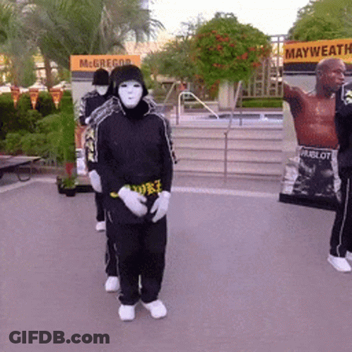 Masked People Standing In Front Of McGregor Sign GIF