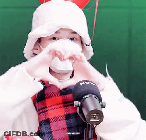 Masked Person Making Heart Beside Cozy Melody Microphone GIF
