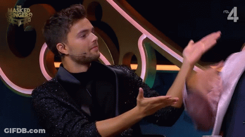 Masked Singer Man Talking To Woman GIF