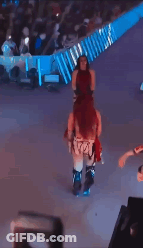 Masked Woman Dancing With Smackdown Sign GIF