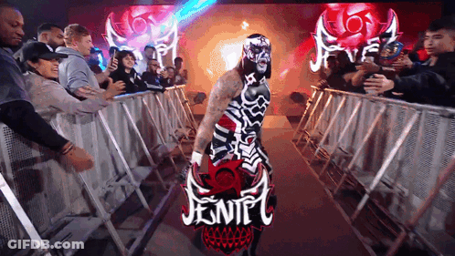 Masked Wrestler Carrying Jentel Sign In Crowd GIF