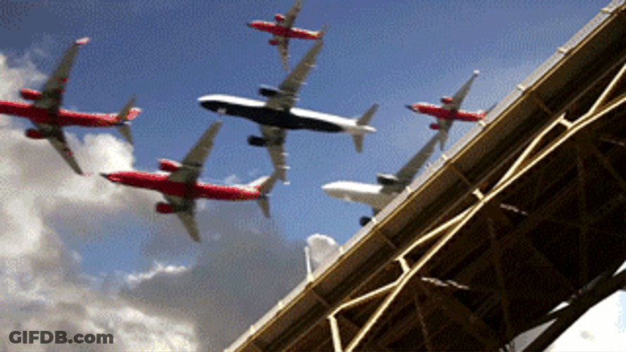 Mass Airplanes Flying Above Bridge GIF