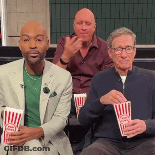 Maury Laughing And Eating Popcorn GIF