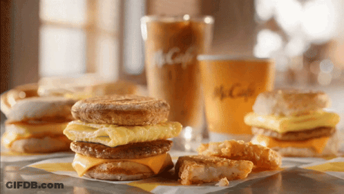 McDonald's Breakfast Sandwich Next To Coffee GIF